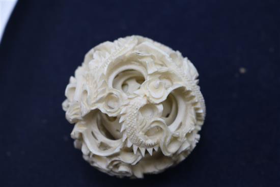 A Chinese carved ivory ball on stand